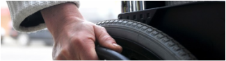 Picture Hand over a Wheelchair Wheel