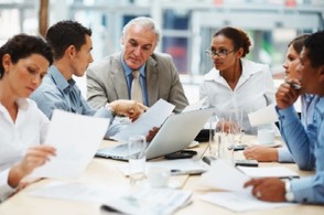 Picture of older Americans working in an office  at a round-table session.
